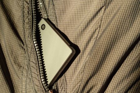 Modern smartphone in jacket pocket. Digital gadgets concept.の写真素材