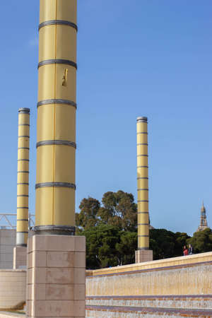 Barcelona, Catalonia  Spain; April 20 2021: Columns next to the Montjuic Communications Tower by Santiago Calatrava (1991) and street lamps in the Anella Olimpica.のeditorial素材