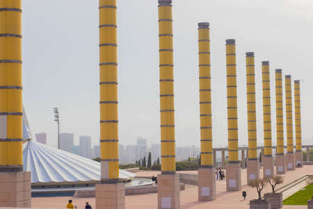 Barcelona, Catalonia  Spain; April 20 2021: Columns next to the Montjuic Communications Tower by Santiago Calatrava (1991) and street lamps in the Anella Olimpica.のeditorial素材