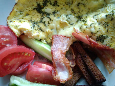 Omelette with pork meat and vegetables tomatoes cucumber and green spices healthy tasty delicious...