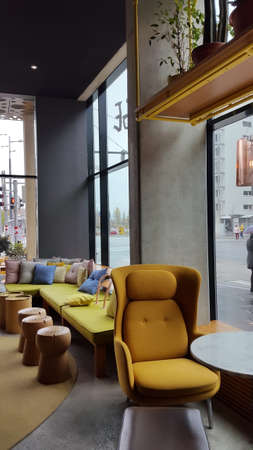 Modern contemporary loft dining room Interior Design with yellow soft chair and barrels instead of tablesのeditorial素材