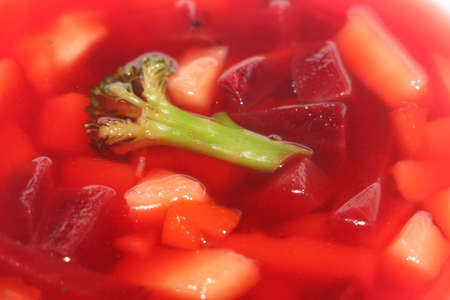 Closeup on spoon getting borscht soup, traditional Ukrainian soup combining meat, beetroots and other vegetablesの写真素材