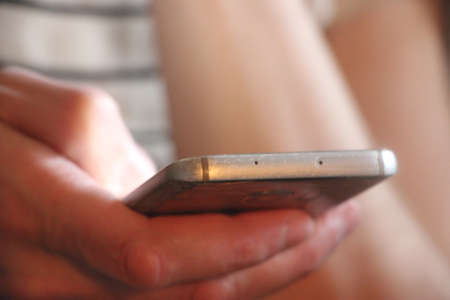 Close up of a man using mobile smart phone.