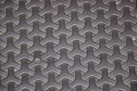 Dark grey regularly woven background texture closeup.