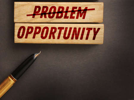 Problem crossed out and opportunity on wooden blocks. Business startup concept.