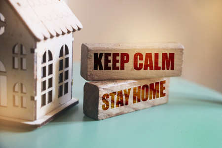 keep calm stay home on wooden blocks. Corona virus prevention pandemic behaviour concept.の写真素材