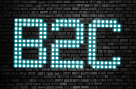 B2C business to customer glowing letters on brick wall. Business marketing conceptの写真素材