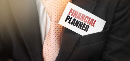 Card with text FINANCIAL PLANNER in businessman suit upper pocket. Finance plan business concept.の写真素材