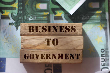 Business to Government B2G on Wooden Blocks put on hundred Euro bills Representing Business 2 Government marketing Model. Business concept.の写真素材