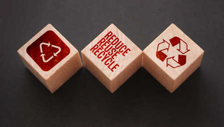Reduce, reuse and recycle word written on wooden blocks on black. Save the planet Ecological concept.の写真素材