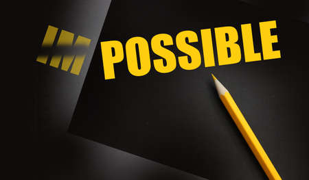 impossible yellow word on black turned to possible. Yellow pencil besides. Motivation coaching concept.の写真素材