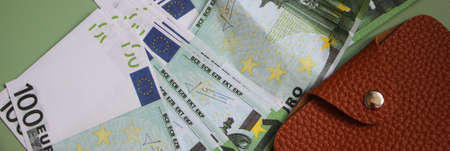 Wallet with many 100 Euro banknotes. brown leather purse. Money conceept.