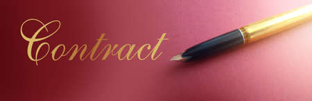 Pen of golden shade with contract document in the background. Business concept.の写真素材