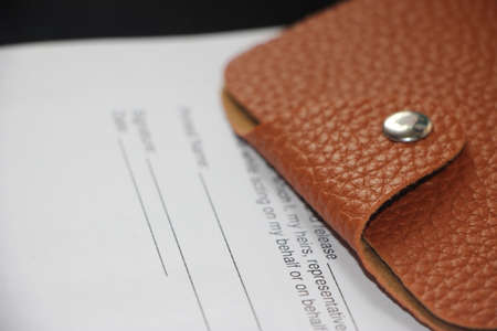 Wallet made of brown natural leather pur on Agreement or contract. Business concept.の写真素材