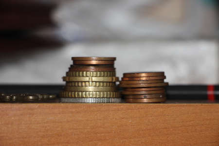 Coins put into two stacks of coins, Savings money and income or Investment Ideas and Financial...