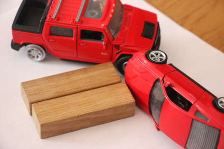 close up of two red toy cars accident. Car insurance road accident car crush test concept.の写真素材