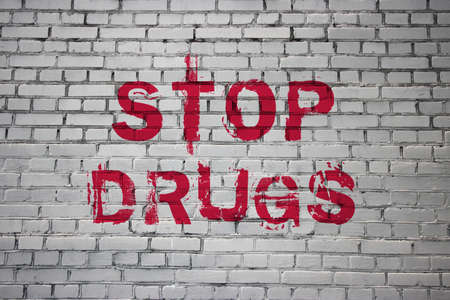 Stop Drugs words on Brick Wall Addiction awareness, Say No to Substances Abuse concept. Motivational...