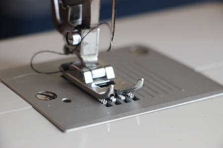 Presser foot of sewing machine threading the textile macro close up. Manufacture business concept.の写真素材