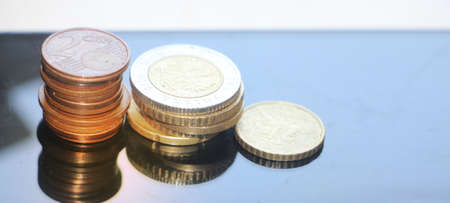 Stacks of coins reminding column diagram going down, Finance and banking loss concept. Copy space for text.の写真素材