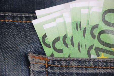 macro 100 euro banknote in jeans pocket. Personal save and spend money concept.