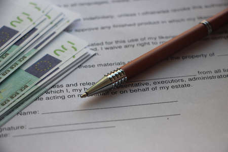 Pen and banknotes on agreement. Profitable Business contract concept.の写真素材