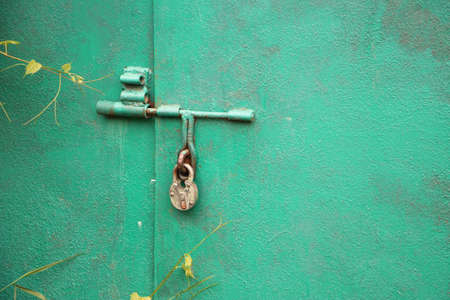 Hanging padlock locked hanging on garage door. Concept of secret information