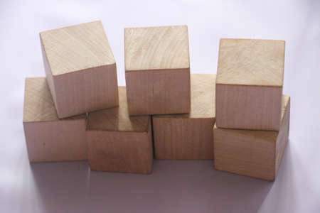 Seven wooden cubes on table over blur abstract light background