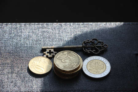 Vintage key and gold coins. Black copyspace on the top. Keys to success motivation achievement business concept.の写真素材