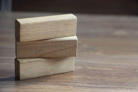 Three blank wooden blocks on wooden table. Education business concept.