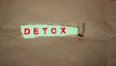 Detox word written under brown packing torn paper pink letters on mint background. Healthcare conceptの写真素材
