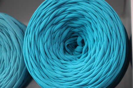 t-shirt yarn balls light blue color on shop shielf. Handmade craft recycle eco concept.