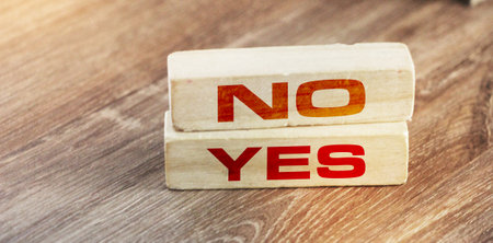 Words YES and NO on wooden blocks on wooden table. Decision making responsibility business conceptの写真素材