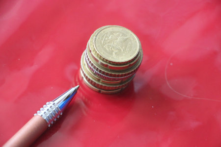 stack of coins and pen. Profit and successful business concept.の写真素材