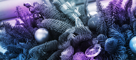 Christmas wrest with baubles and Woman wrapping modern Christmas gifts presents defocused.の写真素材