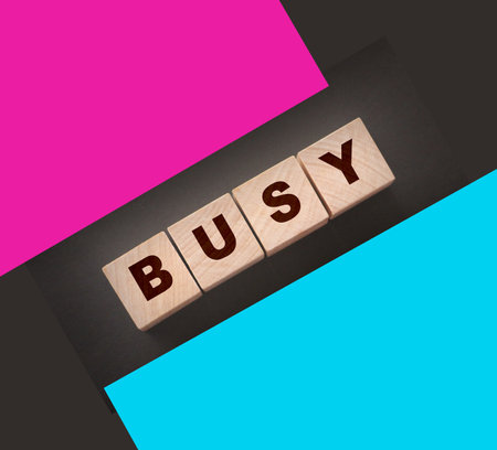 Word Busy made with cube wooden blocks. Business career concept.の写真素材