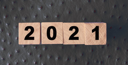 2021 new year on wooden cubes on red leather background. NY congradulation concept.の写真素材