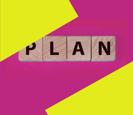 PLAN word on wooden cubes, cubes stand on a blue background. Business and finance conceptの写真素材