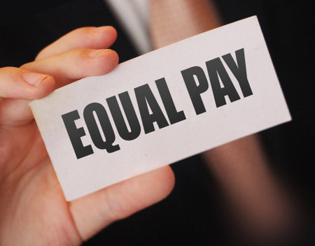 businessman holding a card with text EQUAL PAY. Gender equality business concept.の写真素材