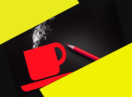 A cup of coffee or hot drink in yellow on black and pencil besides. coffee break. Work and life balance concept.の写真素材