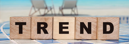 Trend word on cube blocks on relaxed ocean beach background. Business and fashion concept.の写真素材