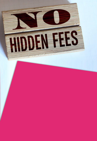 No hidden fees word written on wood blocks and pill of coins. Business agreement transparency and honesty concept.の写真素材