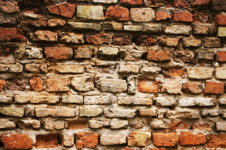 Weathered historical old red brick wall texture. Vintage background.