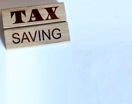TAX saving words on wooden blocks, wallet, coins. Business concept The concept of taxation, increase taxes and fees.の写真素材