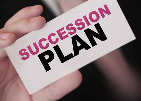 Succession Plan words on a card in hand of businessman. Business profit and success concept.の写真素材