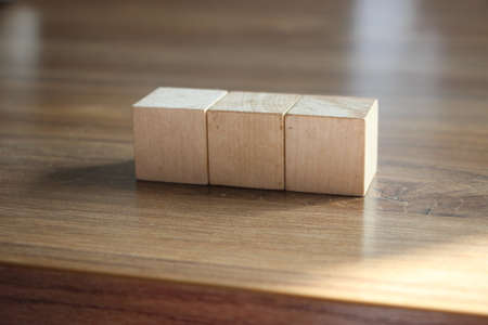 3 Wood Blocks Front View, On Wooden Table, polished wooden table background.