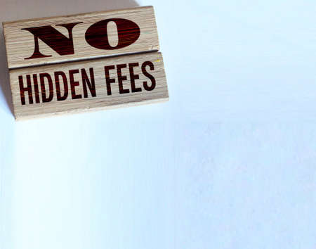 No hidden fees word written on wood blocks and pill of coins. Business agreement transparency and honesty conceptの写真素材