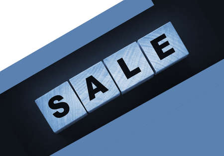 The word sale on wooden cubes on a black background.の写真素材
