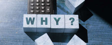 The word Why with quetion mark on wooden Blocks and calculator. Business crisis conceptの写真素材