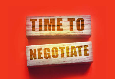 time to negotiate text on wooden blocks. Business deals agreement and negotiations concept.の写真素材