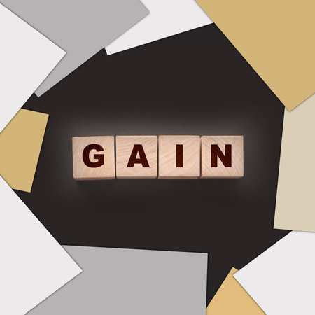 Gain word on wooden cubes with letters on black. Business profit conceptの写真素材